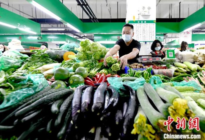 8月9日，拉薩市一農(nóng)貿(mào)市場內(nèi)，經(jīng)營者正在擺放菜品。據(jù)拉薩市官方當(dāng)日召開的新聞發(fā)布會消息，拉薩生活必需品儲備充足。記者 李林 攝