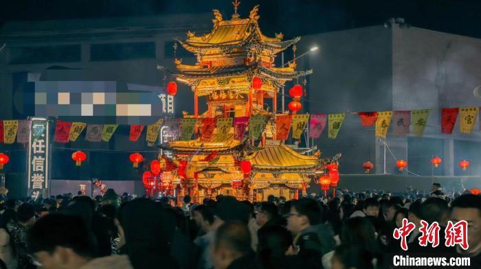 “盤(pán)子”下人頭攢動(dòng)、香煙繚繞，“盤(pán)子”上禮花怒放、爆竹震天，一派人壽年豐的和樂(lè)景象。　劉冠瓊 攝