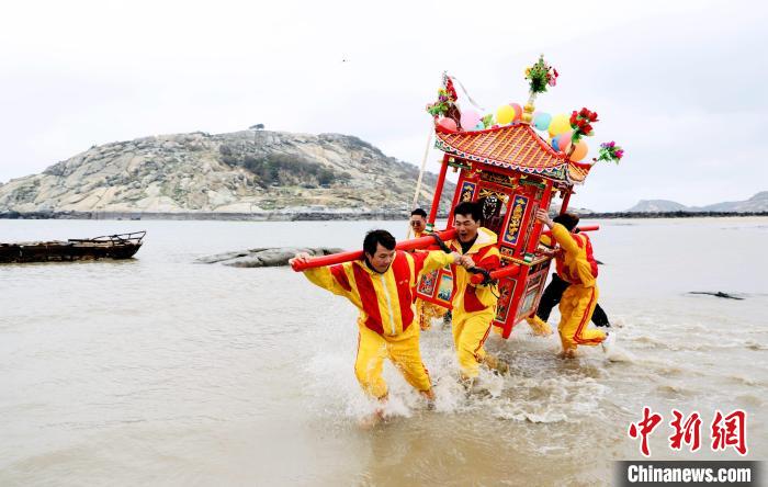 信眾抬著神轎沖海祈福。　陳斌 攝